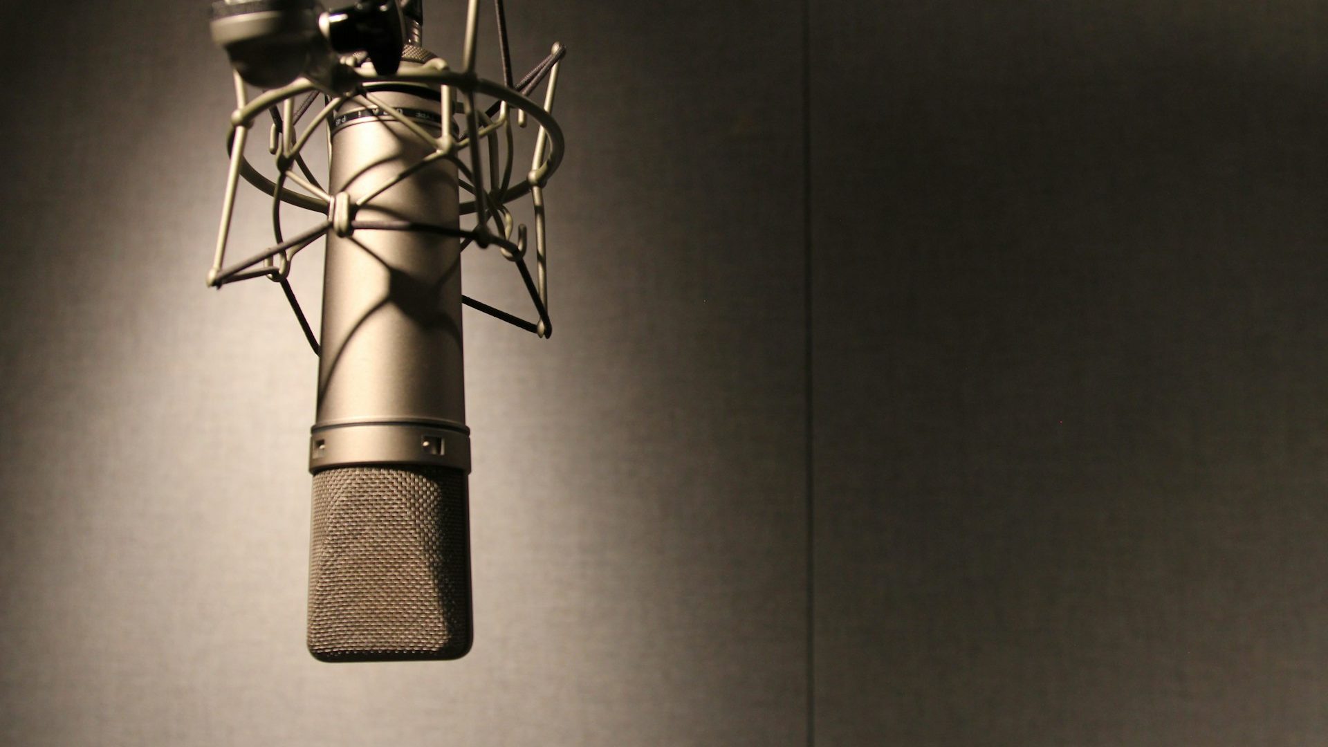 A studio microphone on a dark table