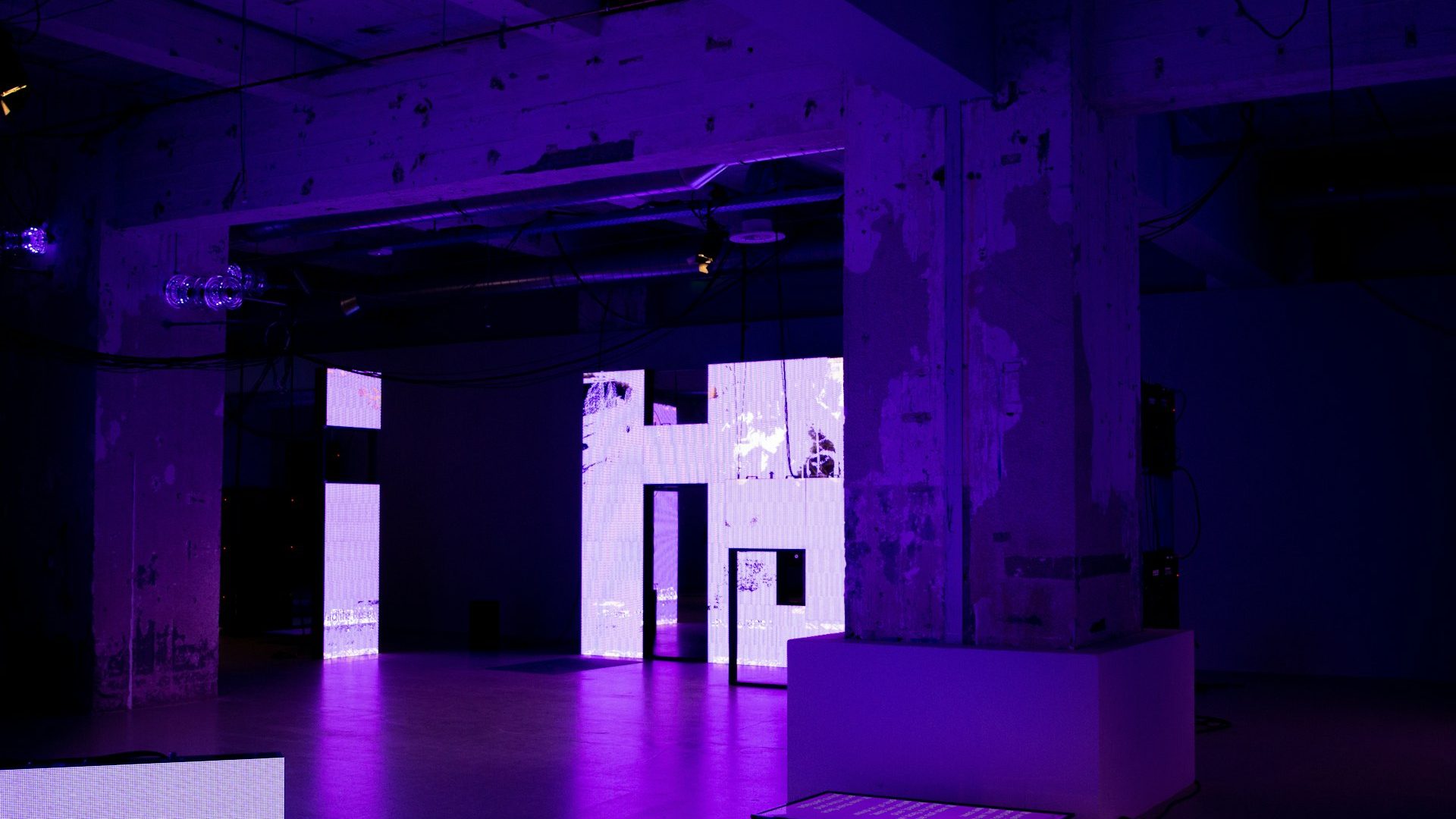 An empty room washed in purple LED light
