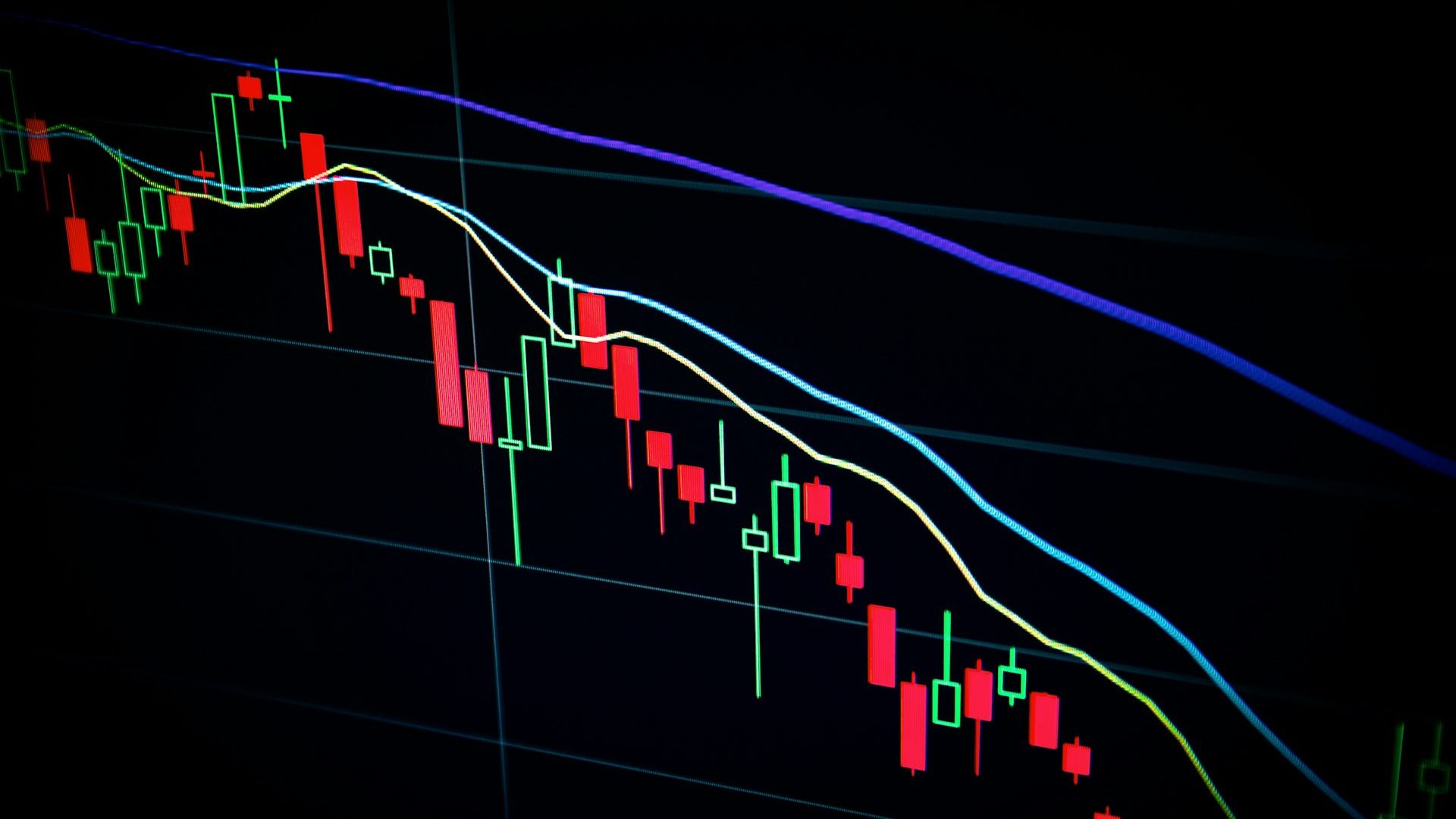 A candlestick trading chart on a dark screen