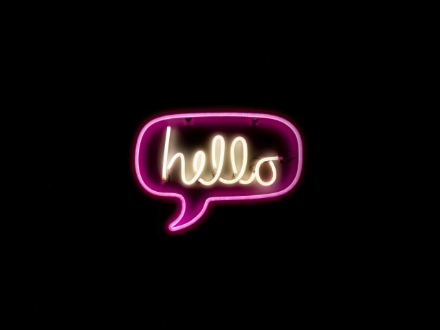 Pink and yellow neon sign reading hello