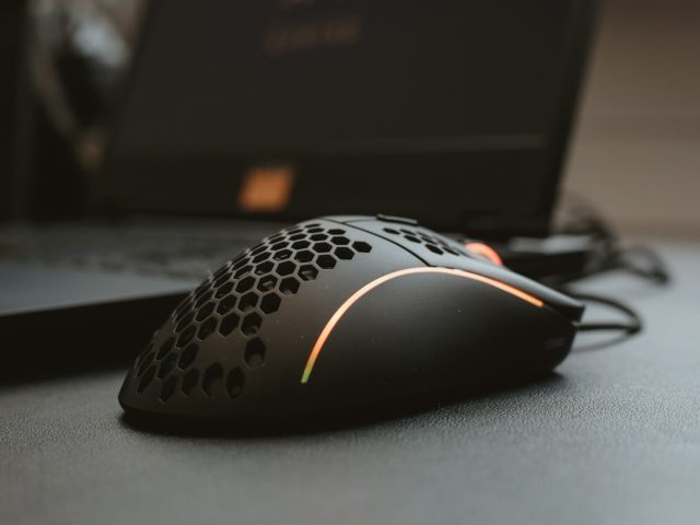 A corded computer mouse on a desk