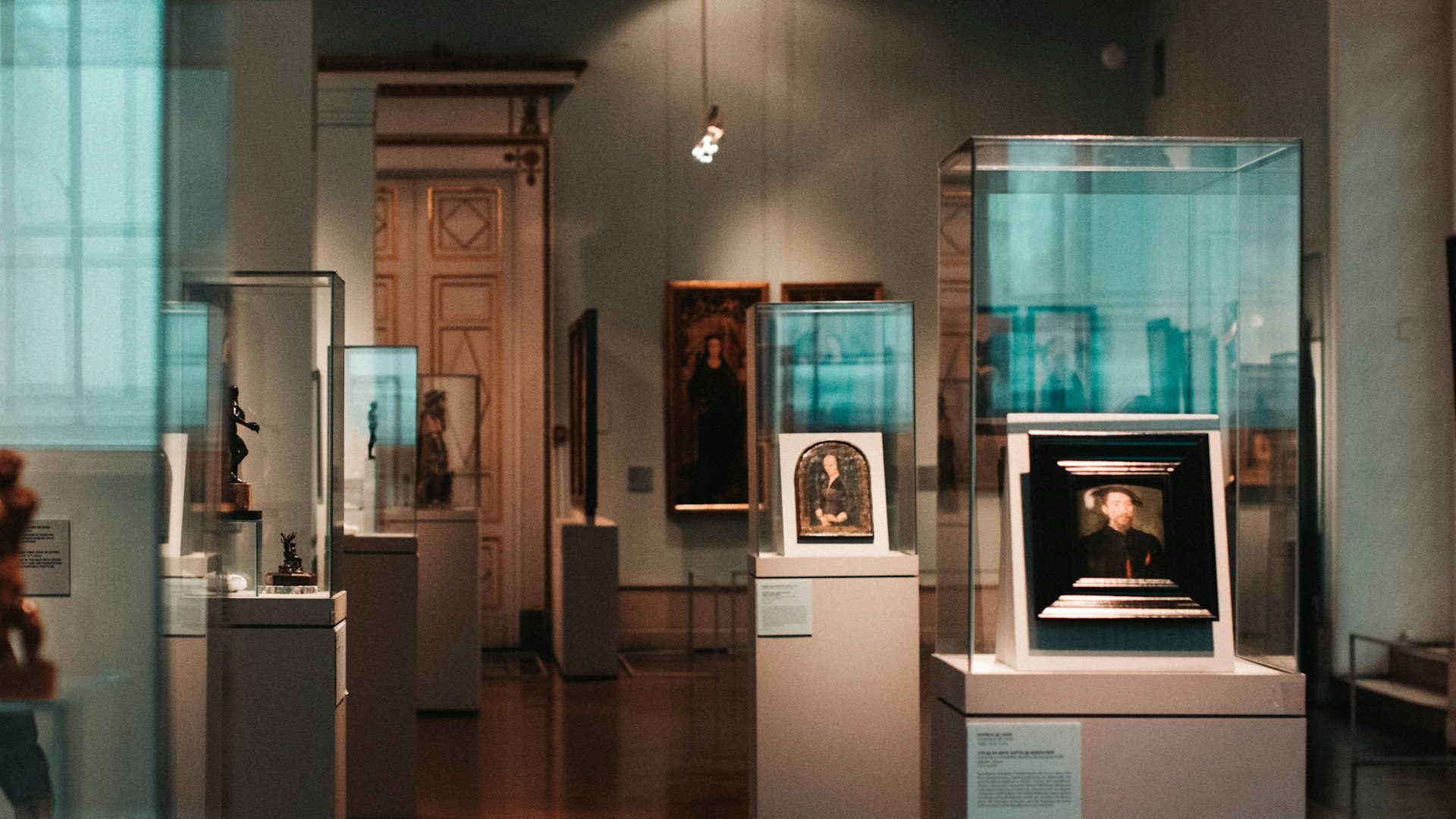 A museum room lined with glass display cases