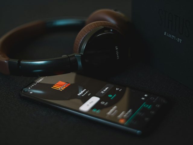 Headphones beside a remote control