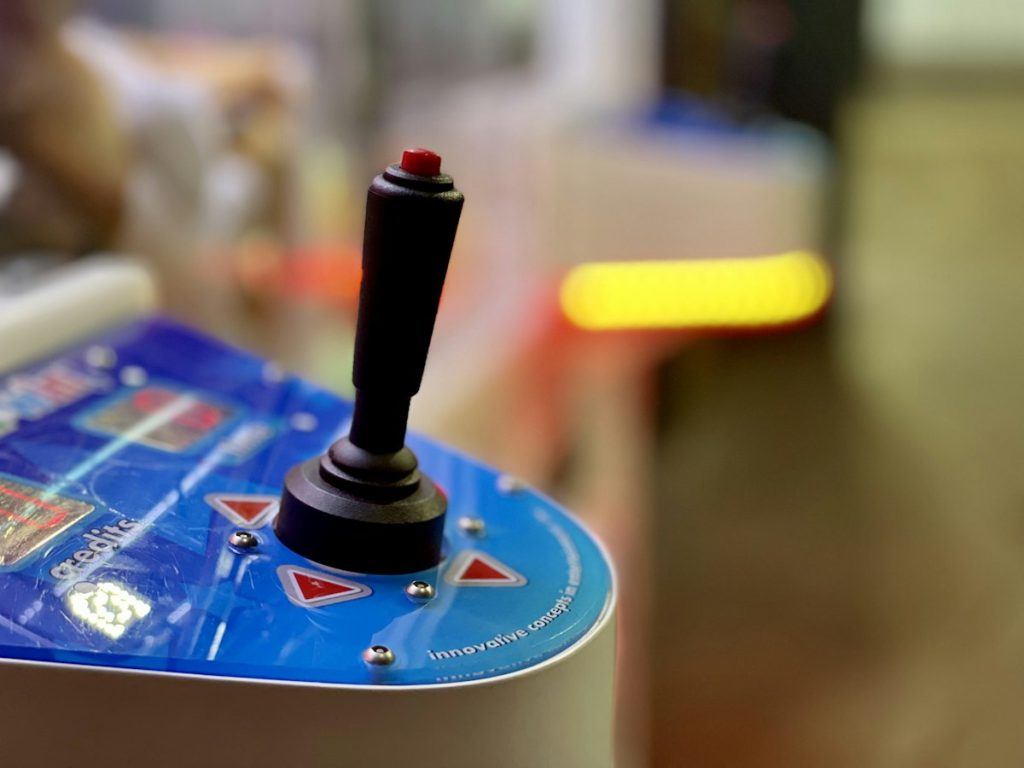 Close-up of a red and black arcade joystick