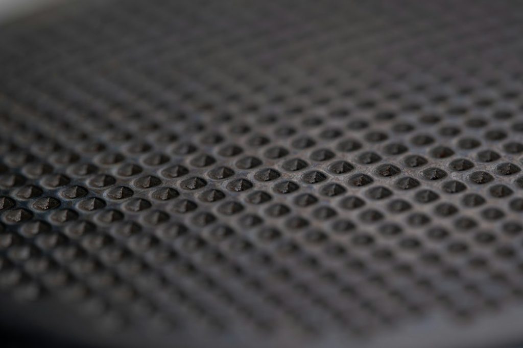 A close-up of a dark, scratched disc surface