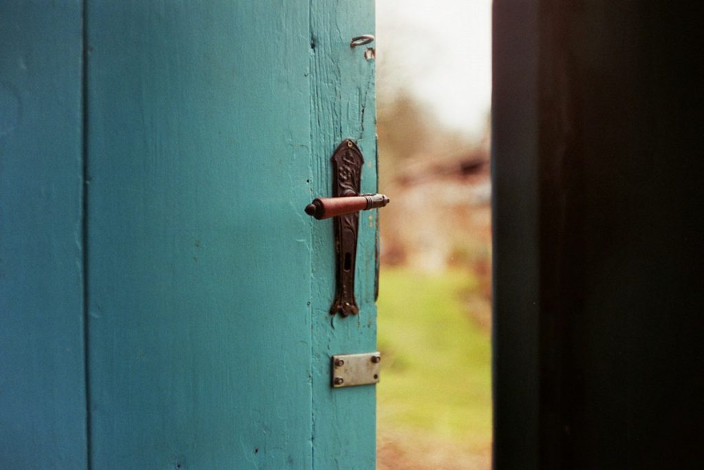 A weathered blue wooden door