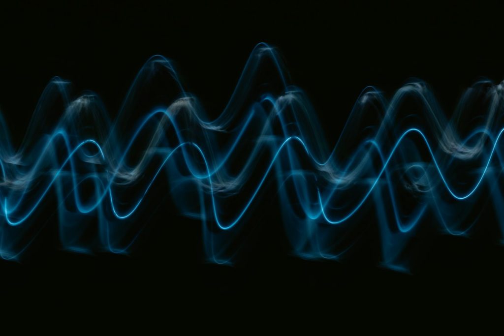 A blue wave of light against a black background