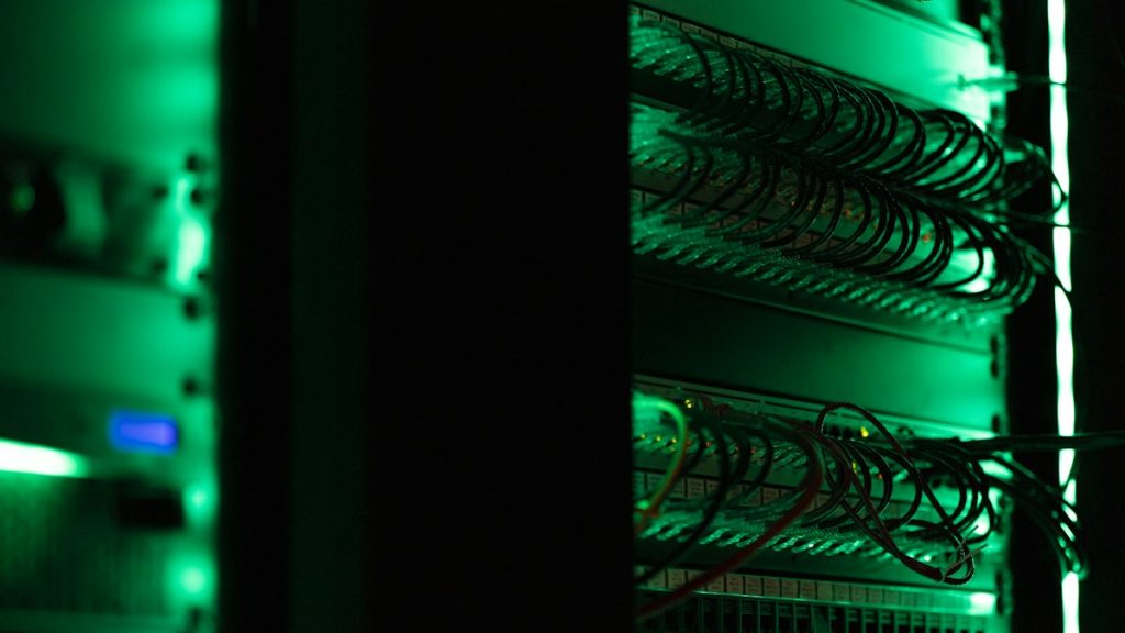 Racks of electronic equipment in a dark server room