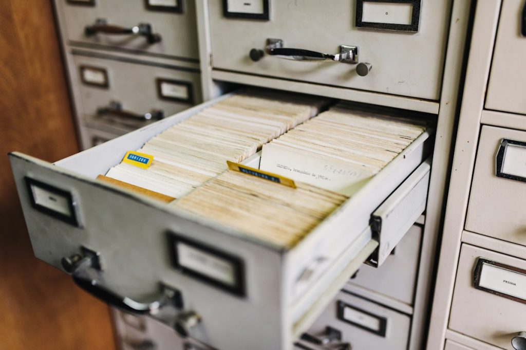 A row of metal filing cabinet drawers