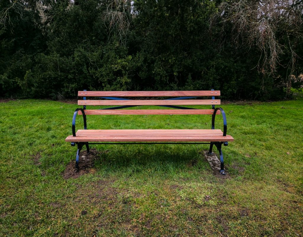 A lone wooden bench in an open field