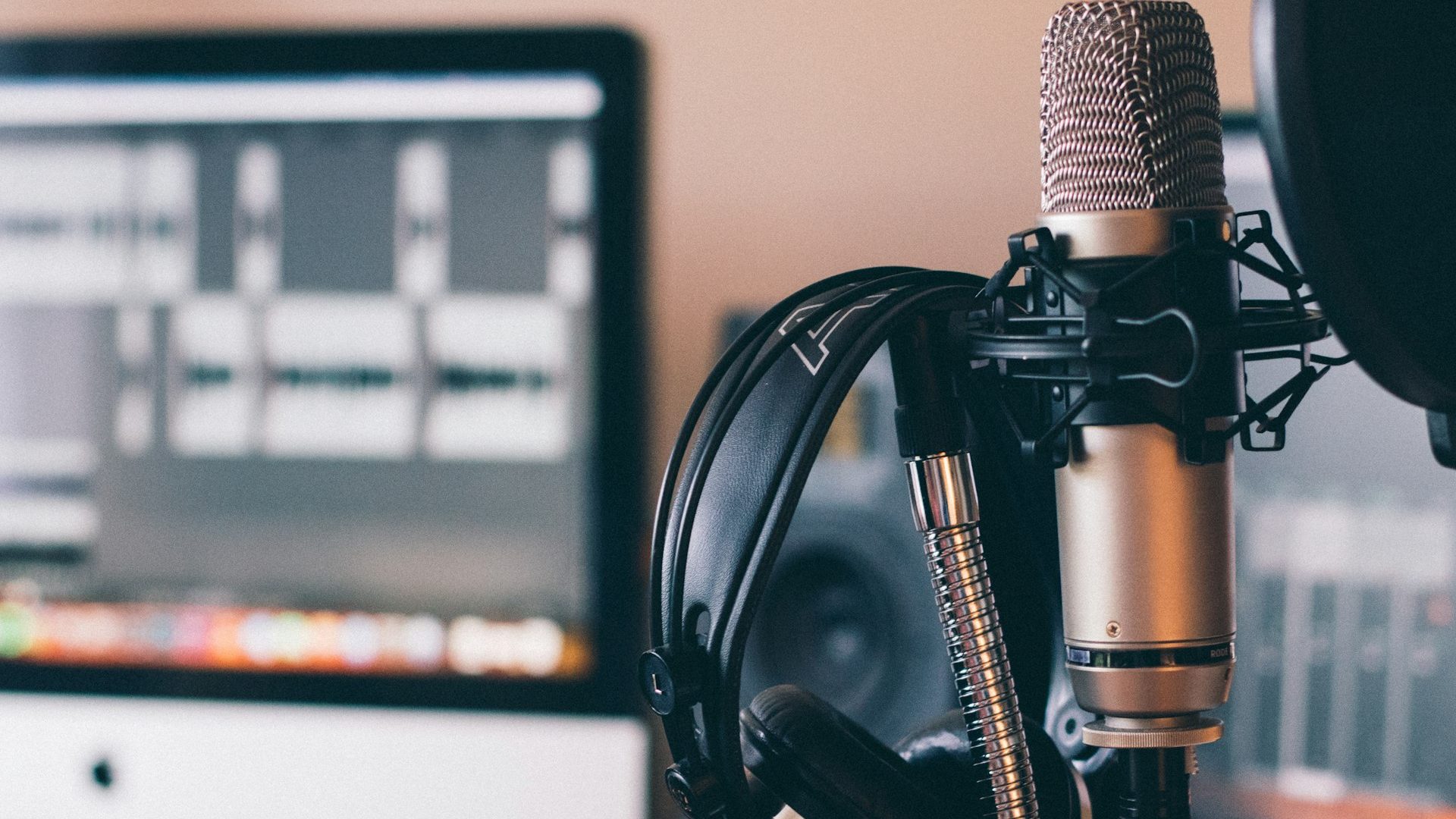 Headphones resting on a studio microphone