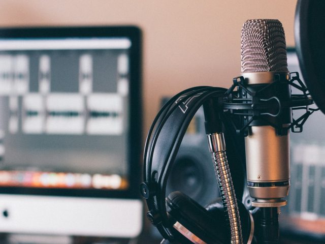 Headphones resting on a studio microphone