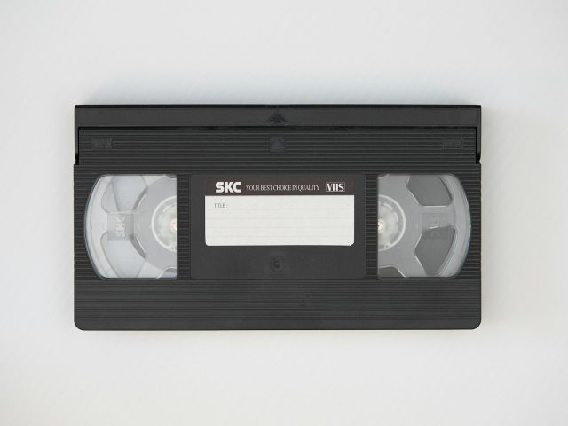 A black cassette tape on white fabric