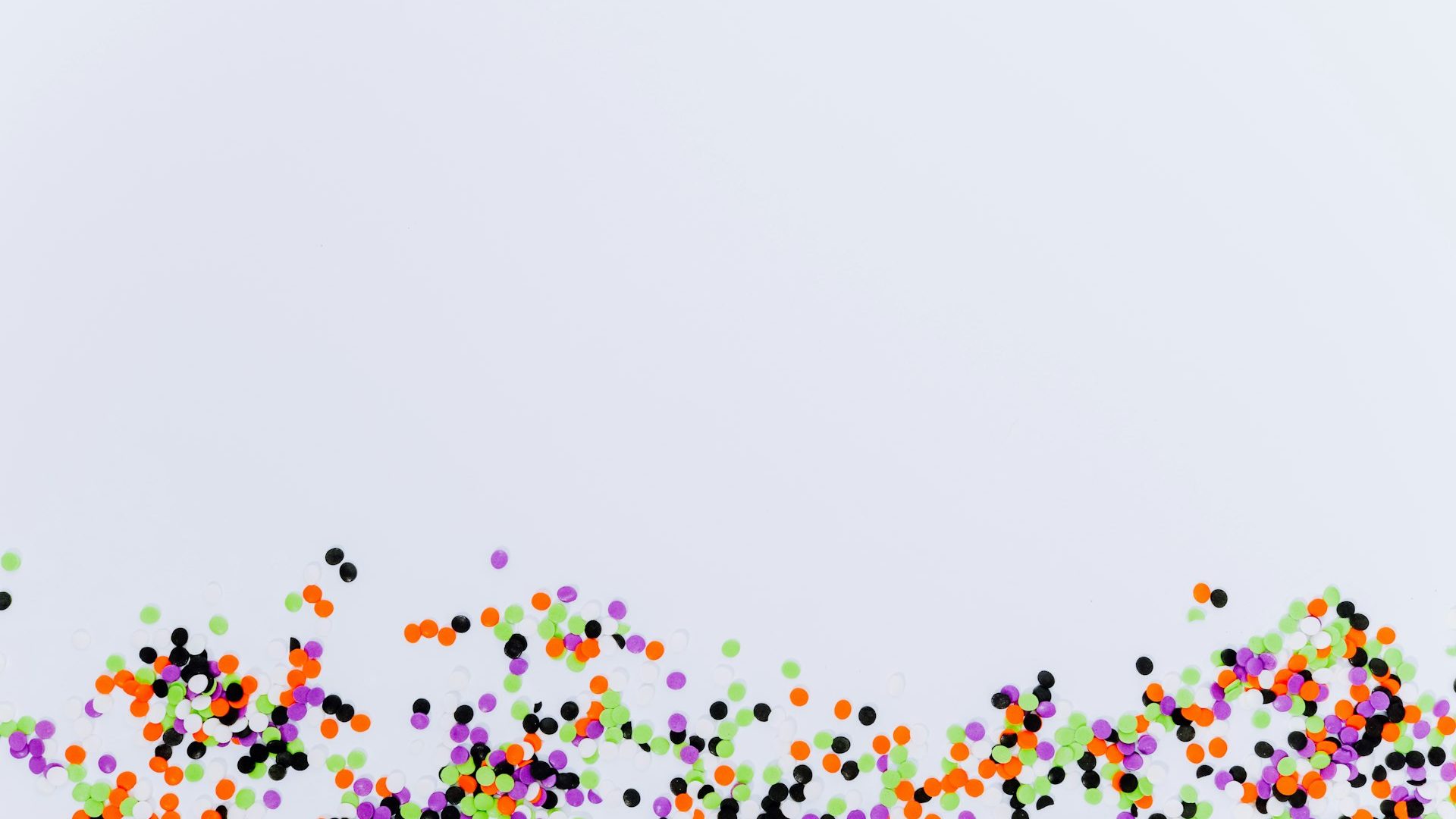 Multicoloured balls scattered across a bright surface