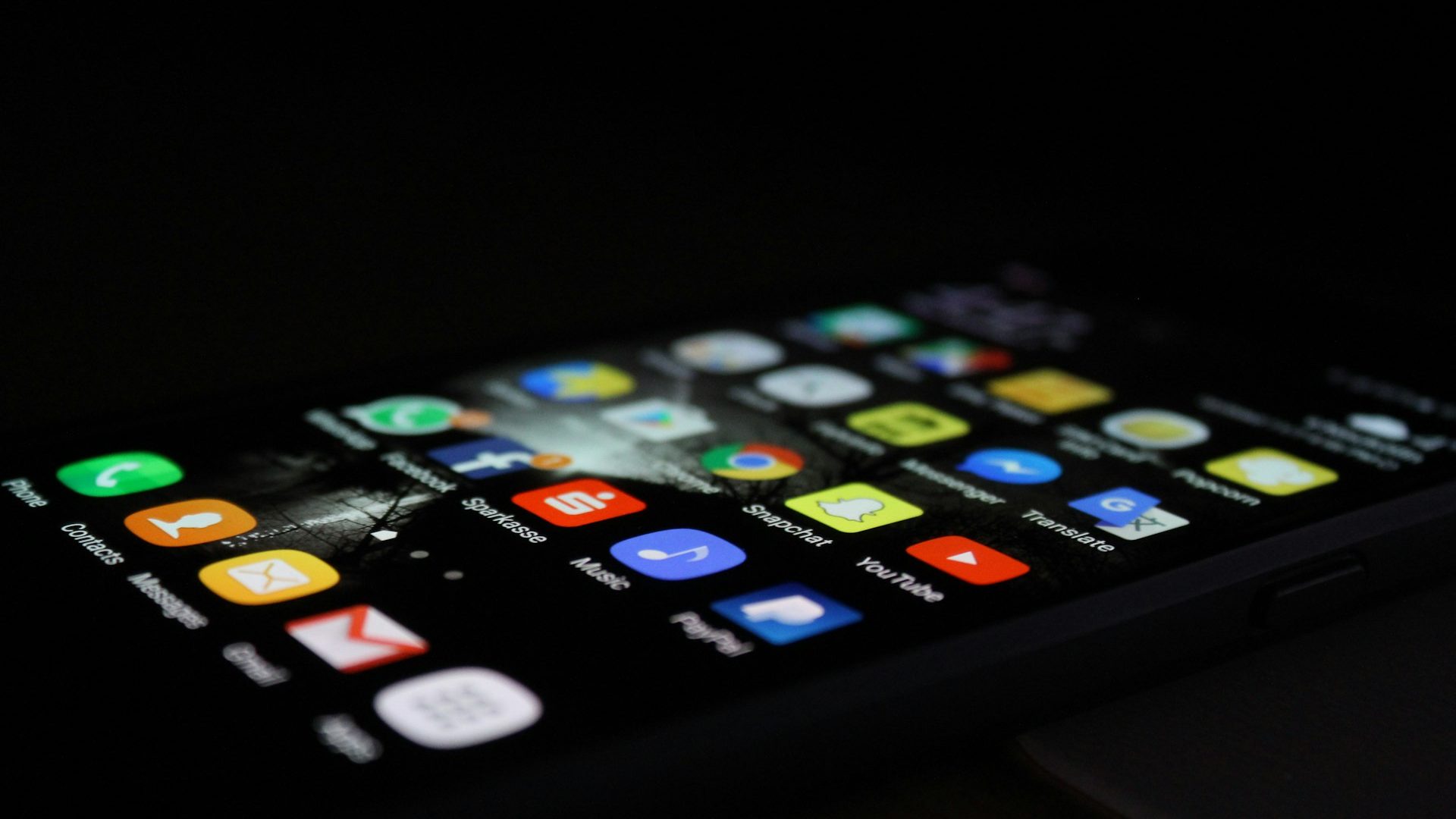 A smartphone lying on a dark surface