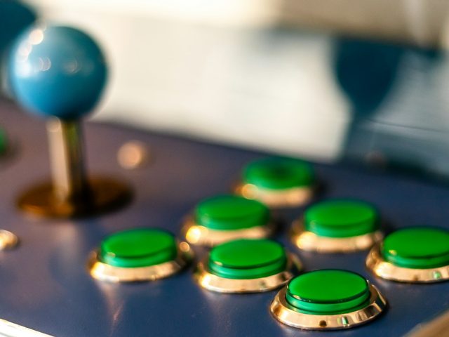 Close-up of glowing green arcade buttons