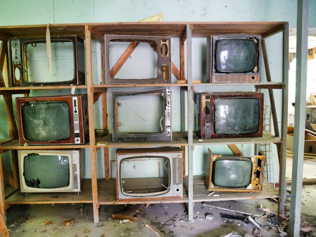 A vintage television set with a glowing screen