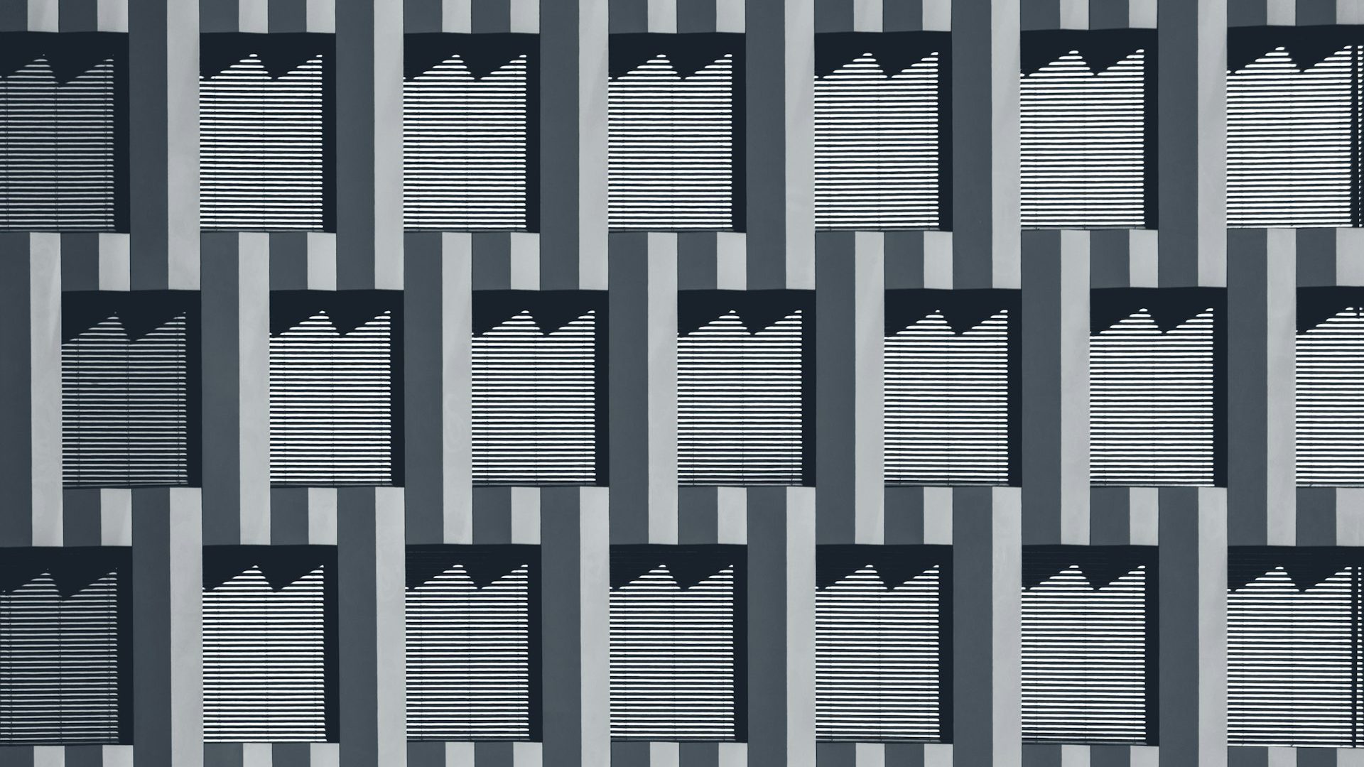 A repeating grey geometric pattern